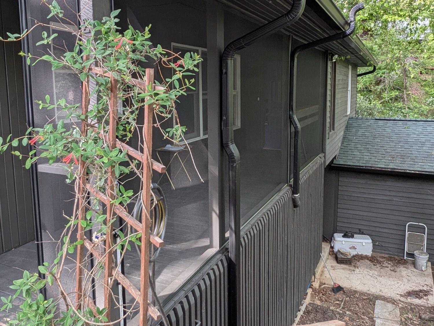 The same porch screened floor to header, with matching vertical-slat skirting run below it.